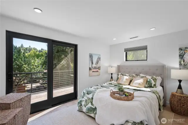 A bedroom on the upper floor with the deck access