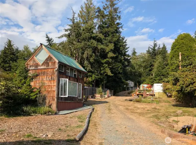 Tiny home on the left and view of the rest of the property