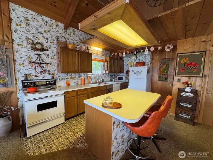 The kitchen island enhances the functionality of the kitchen.