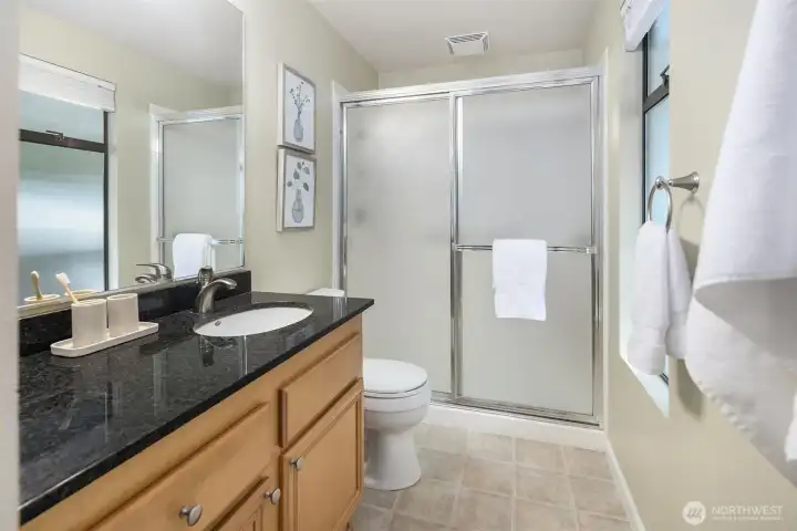 Master bedroom with remote operated low profile ceiling fan with light, French doors, large closet, and attached 3/4 bath.