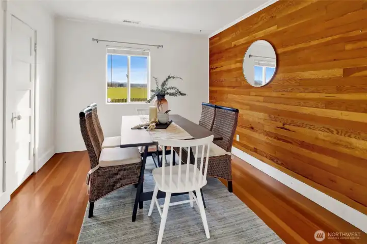 The large dining room features a wood accent wall