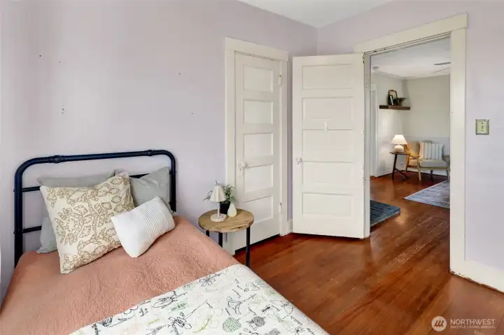 The secondary bedroom has a spacious closet and is adjacent to the living room