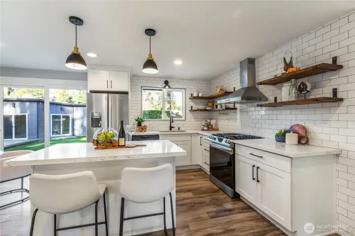 Kitchen features natural light and sleek cabinetry.
