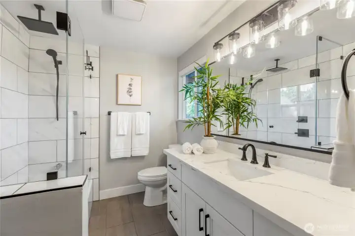 Updated bathroom with with ample vanity space and natural light.