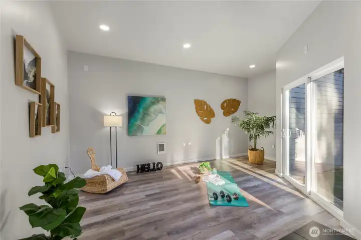 Bright and versatile detached studio with luxury vinyl flooring, recessed lighting, and sliding glass doors—perfect for a home gym, yoga retreat, or creative workspace.