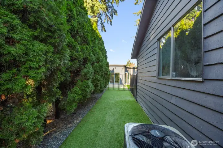 Private, fenced turf dog run—perfect for pets to play safely in a low-maintenance outdoor space.
