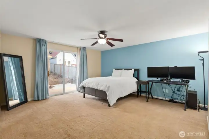 Primary bedroom with slider to private patio.