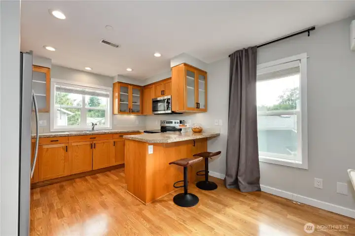 Kitchen with stainless steel appliances, all appliances stay! Cute breakfast bar.