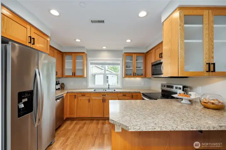 Kitchen is a dream with lots of counterspace and storage. Fridge, dishwasher, range and microwave all stay.