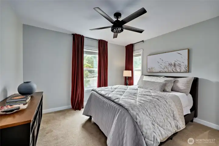 Primary bedroom with ceiling fan.