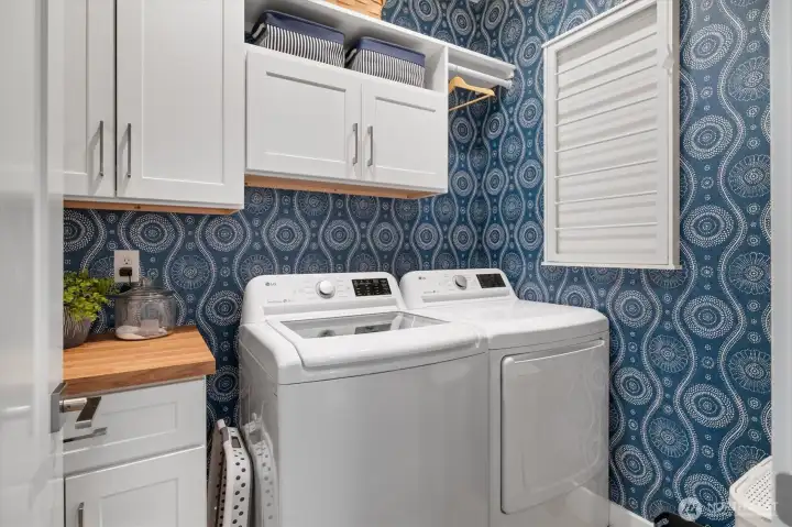 Spacious laundry, custom wall coverings.
