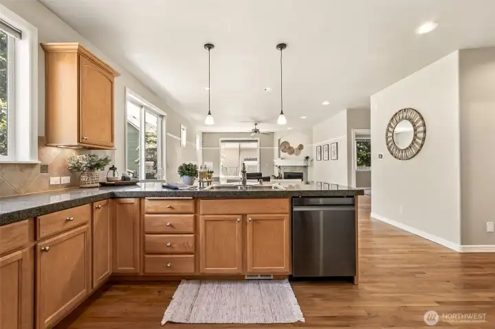 The heart of the home shines with granite counters, stainless appliances, and warm wood cabinetry. The open-concept design keeps the cook connected to the great room, eating bar and kitchen dining space. The heart of the home shines with granite counters, stainless appliances, and warm wood cabinetry. The open-concept design keeps the cook connected to the great room, eating bar and kitchen dining space.