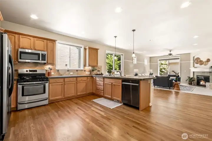 This seamless flow from kitchen to living room is ideal for entertaining and everyday living. Natural light and thoughtful finishes create a welcoming, functional space. Beautiful oak hardwoods gleam throughout the main living area. This seamless flow from kitchen to living room is ideal for entertaining and everyday living. Natural light and thoughtful finishes create a welcoming, functional space. Beautiful oak hardwoods gleam throughout the main living area.