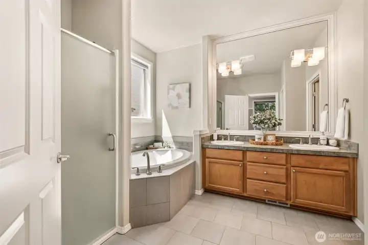 A spa-inspired 5-piece bath features a soaking tub, dual sinks, and accessibility-minded upgrades. The thoughtful design supports comfort, safety, and long-term livability. A spa-inspired 5-piece bath features a soaking tub, dual sinks, and accessibility-minded upgrades. The thoughtful design supports comfort, safety, and long-term livability.