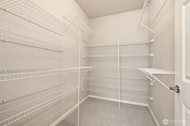 A spacious walk-in closet offers abundant storage and organization. It’s a practical, well-designed extension of the primary suite. A spacious walk-in closet offers abundant storage and organization. It’s a practical, well-designed extension of the primary suite.