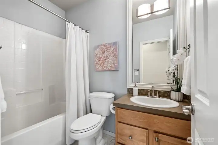 The bright, modern full guest bath features a clean, neutral palette. Perfect for visitors or everyday use. The bright, modern full guest bath features a clean, neutral palette. Perfect for visitors or everyday use.