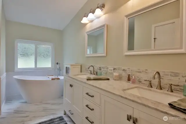 Primary Bath - marble countertops, soaking tub, walk in shower.