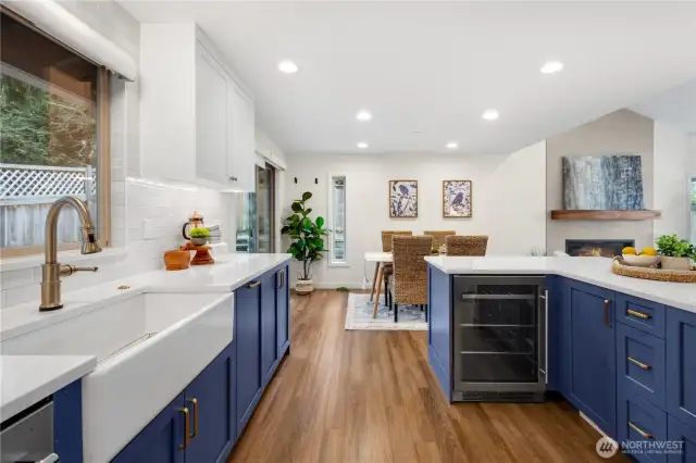 Gourmet kitchen with wine/beverage fridge and farmhouse sink.