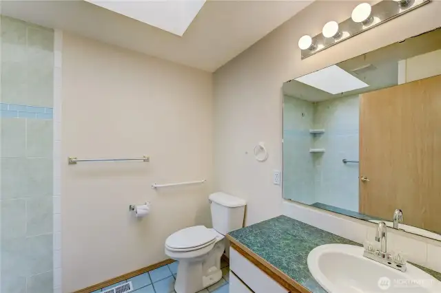 Unit B Primary Bathroom. Now has a new flooring and shower doors.