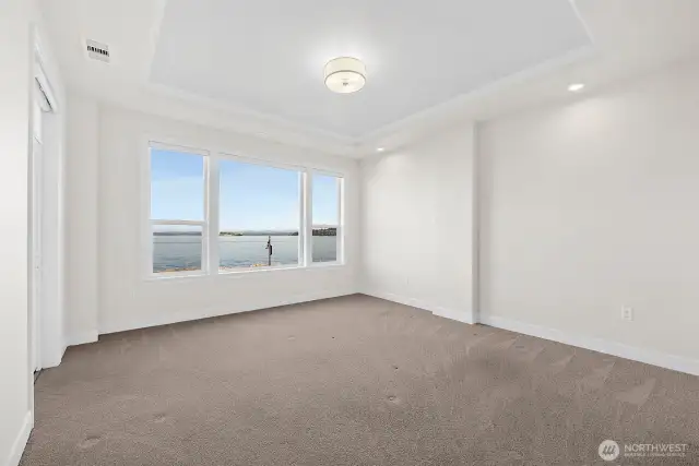 The ultimate luxury – waking up to those incredible views right from your bed in this spacious primary bedroom.