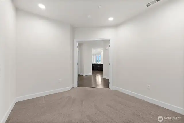 Third bedroom or den with double doors leading out to the main living area.