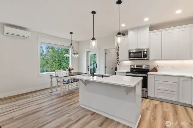 Loads of cabinets w/ tall uppers and quartz counters