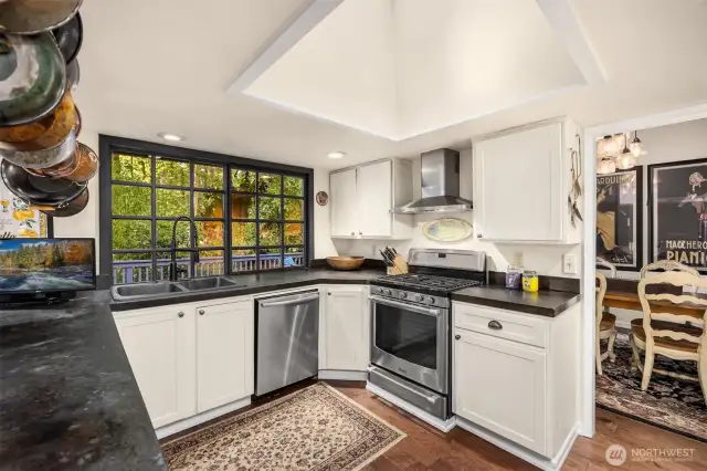 A large window to back yard and deck, plus overhead skylight