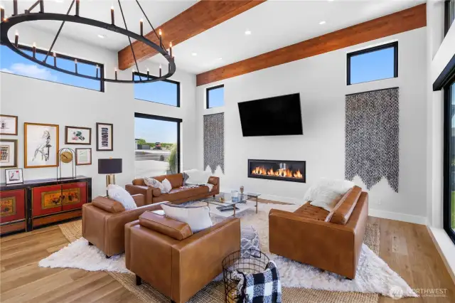 Living room. Features high ceilings, windows and wood beams throughout.
