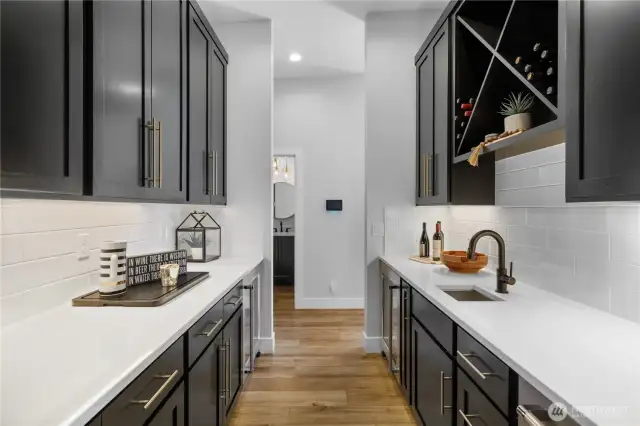 Butler’s pantry featuring Kitchen Aid fridge and ice maker.
