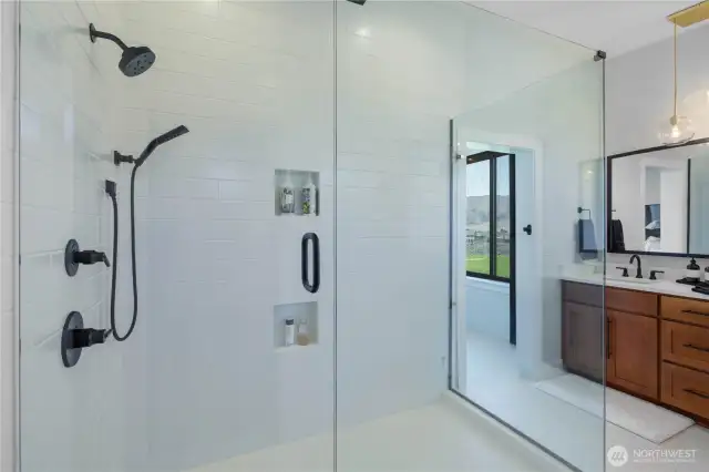 Primary bathroom with walk-in tile shower.