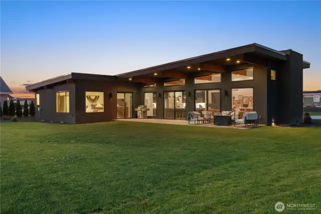 Back of home shot twilight. Views from every room with an abundance of natural light.
