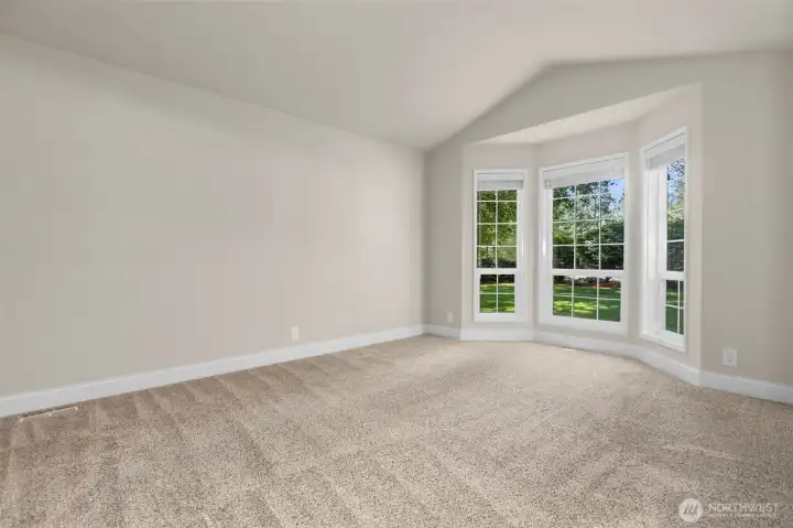 Formal living room is to the right as you enter - the oversize bay window captures the park-like setting