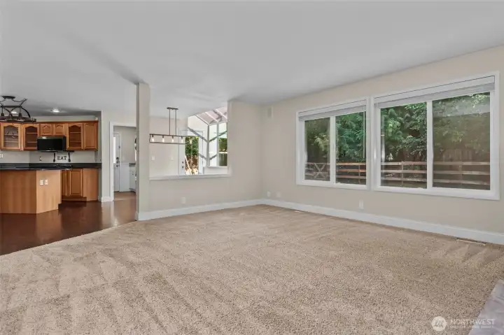 Family room has a forested view and opens to the kitchen and nook