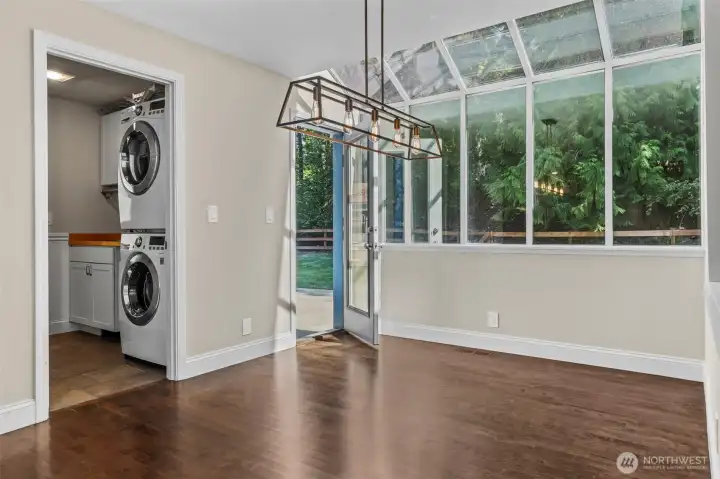Skywall in the breakfast nook with views of the trees, and a back door off the nook plus another out of the mudroom
