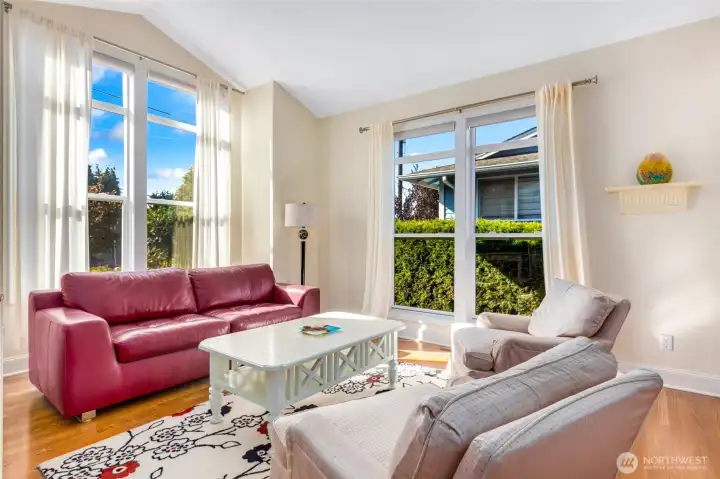 Front sitting room/office with floor to ceiling windows is a beautiful flex space