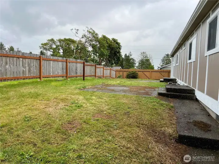 Spacious back yard partially fenced