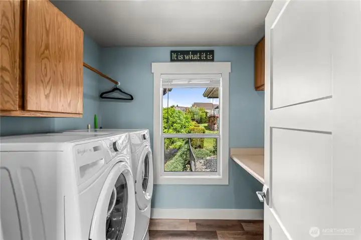 Main Floor laundry with folding counter and natural light.