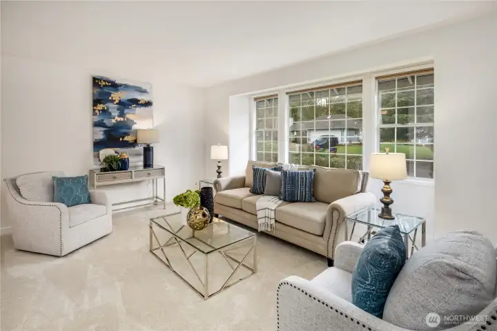 Wall of windows in this light and bright living room.