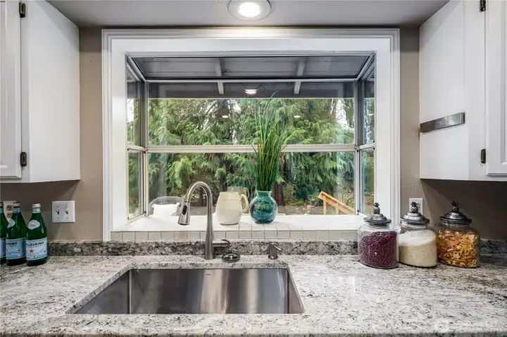 Kitchen view looking out towards the backyard and nature space.