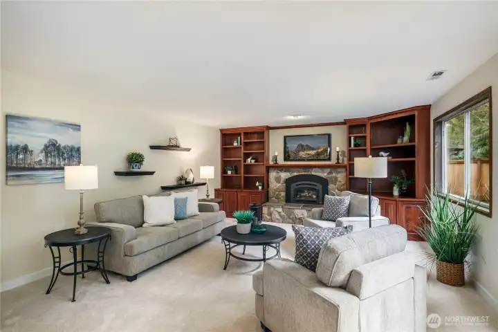 Fabulous family room features gas fireplace, and built-in cabinets.