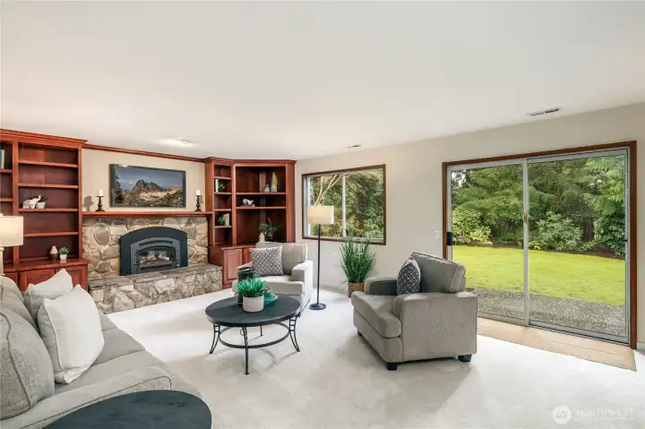 Family room features a slider to the back patio and scenic views of the woods behind the backyard.