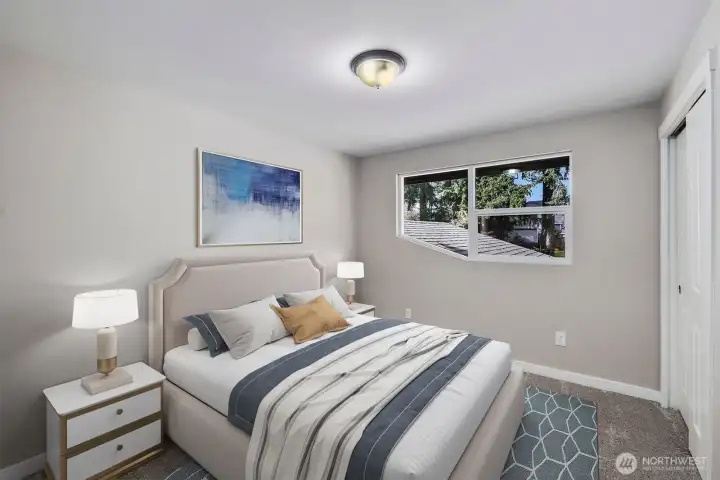 Virtually staged upstairs bedroom with closet space and natural light in this 4 bedroom Puyallup home.