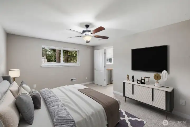 Virtually staged spacious upstairs bedroom with ceiling fan and natural light in this Puyallup School District home.