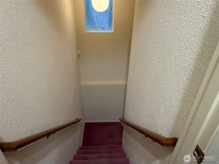 Stairs to lower level separated by man door