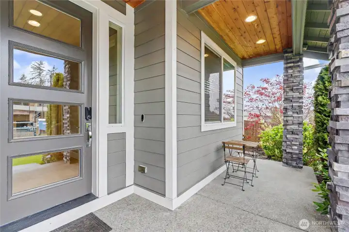 Front porch view, generous stone pillars, classic PNW wood ceilings and contemporary touches throughout this amazing home.