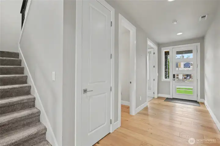 As you enter the home, you will note the gorgeous flooring throughout this first level. On your right is the front bedroom/office, followed by the first floor powder room and large coat closet.