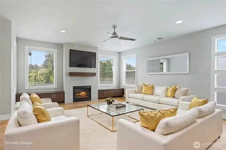 Down the hall to your right you will find your massive family room. Look at those windows! Gas fireplace to keep you cozy on cooler days and nights with amazing built-ins on both sides, convenient ceiling fan to move air up or down depending on the season. To your right, notice the contemporary windows, frosted for privacy. ***Virtually Staged***