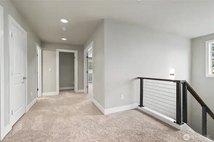 As you head upstairs, you will love the stairway window letting in all the light, and this large landing area and wide hallways really adding to the open feel of this floor.