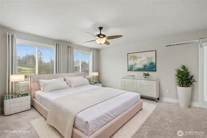 Upstairs Primary Ensuite Bedroom view, GENEROUS in size, more massive windows, convenient ceiling fan and barn door leading to your bath, a real retreat! ***Virtually Staged***