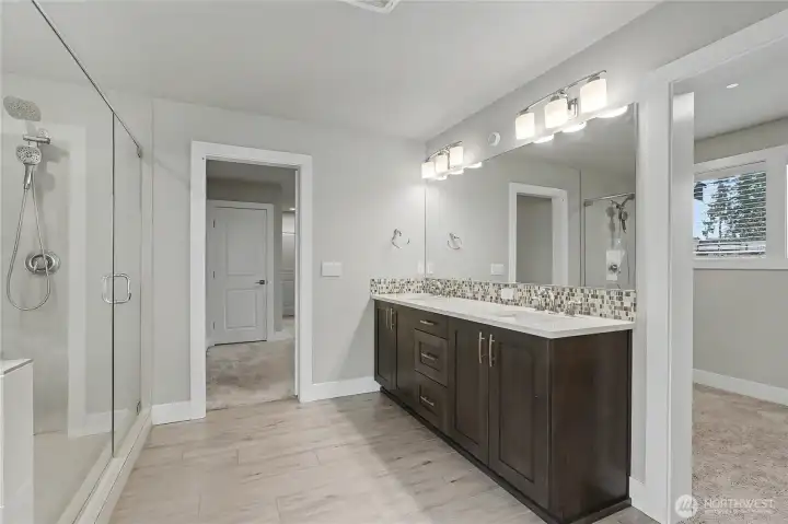 View of your primary bath looking back towards the bedroom, walk-in closet to your right.